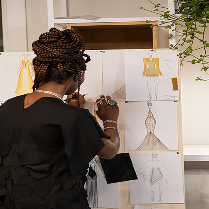 woman creating fashion sketches